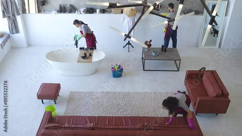 A team of professional cleaners working in a contemporary living space. Cleaning services for home, office or studio. Top view, timelapse