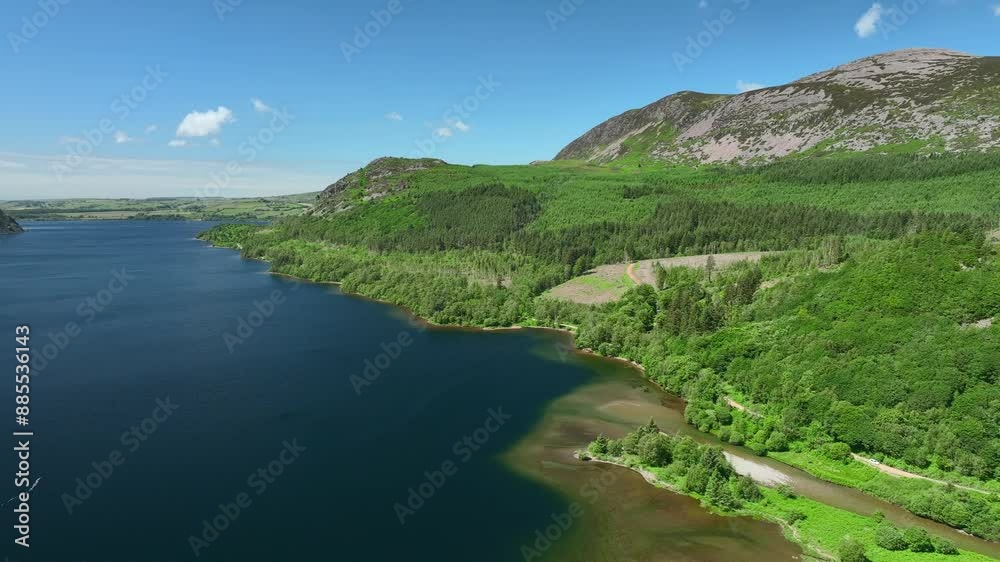 Blue lake with forested and hilly shoreline. Ennerdale, English Lake District, Cumbria, UK Blue lake with forested and hilly shoreline. Ennerdale, English Lake District, Cumbria, UK