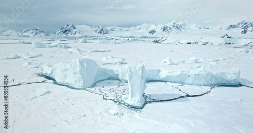Amazing frozen arctic polar nature landscape. Snow covered icebergs, glacier and mountain range. towering ocean cost bay. Polar cold landscape. Antarctic travel and exploration. Aerial drone flight