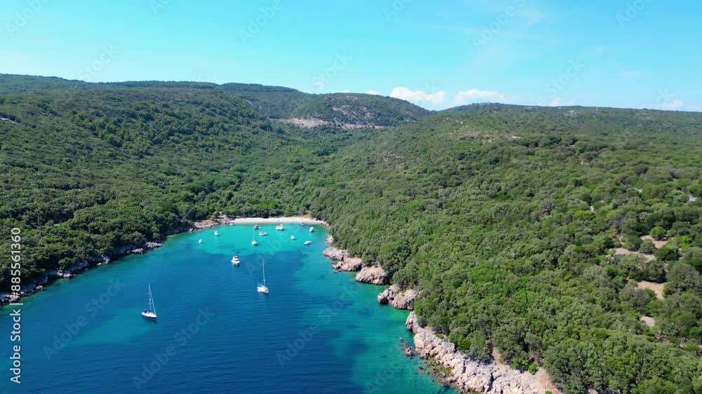 An aerial view of the Blue Lagoon at Plaža Krušćica and Tarej Beach on the island of Cres, showcasing their fantastic turquoise waters and surrounding islands. Boats dot the serene lagoon An aerial view of the Blue Lagoon at Plaža Krušćica and Tarej Beach on the island of Cres, showcasing their fantastic turquoise waters and surrounding islands. Boats dot the serene lagoon