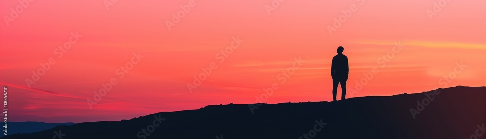 Silhouette of a Person Standing on a Hilltop Against a Vibrant Sunset Sky Silhouette of a Person Standing on a Hilltop Against a Vibrant Sunset Sky