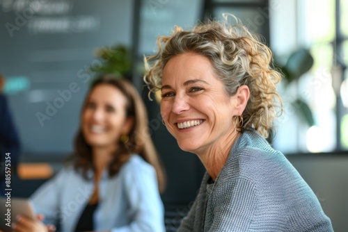 Happy middle-aged businesswoman smiling during a meeting in a modern office