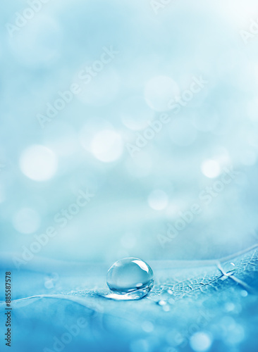 close-up of a drop of sparkling water on a blue background with bokeh. photo