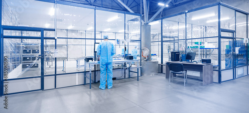 Foto Worker on workplace to sterile box for production of medical equipment made of non woven material and surgical kits for operation