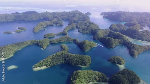 Aerial View Of Koror Island. Many Green Islets. Palau Seascape With Colorful Coral Reefs And Tropical Lagoons. Cityscape in Background. Drone.