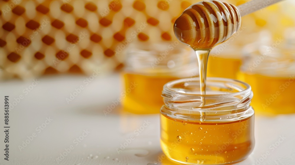 A jar of honey is poured into another jar A jar of honey is poured into another jar