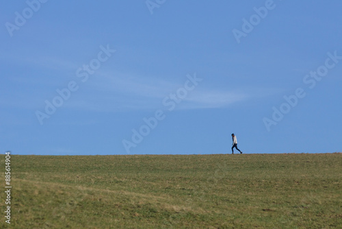 Wallpaper Mural Person walking on open field under clear sky Torontodigital.ca