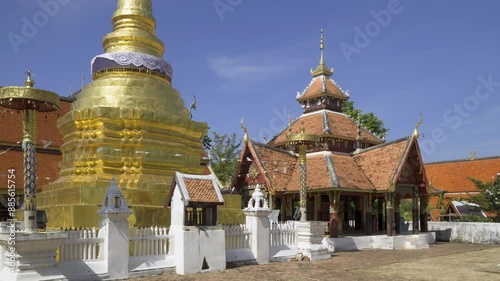 Golden pagoda and Buddha pavilion at Wat Pong Sanuk temple in Lampang, north of Thailand
