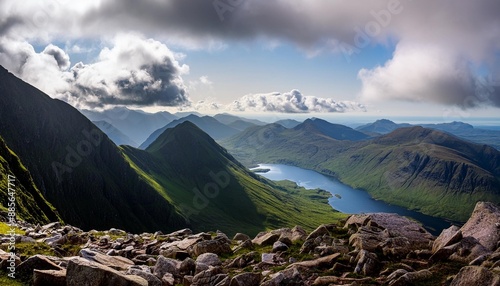 views of the summits of cul mor and an laogh with loch an doire dhuibh below from the summit of stac pollaidh in the scottish highlands on a sunny summers day with dramatic clouds in the uk photo