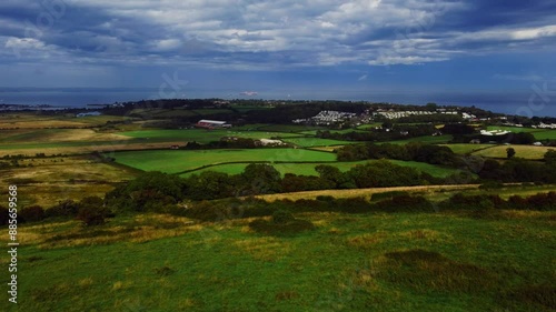 Drone footage of the green rolling fields near Bembridge village in the Isle of Wight, England, UK photo