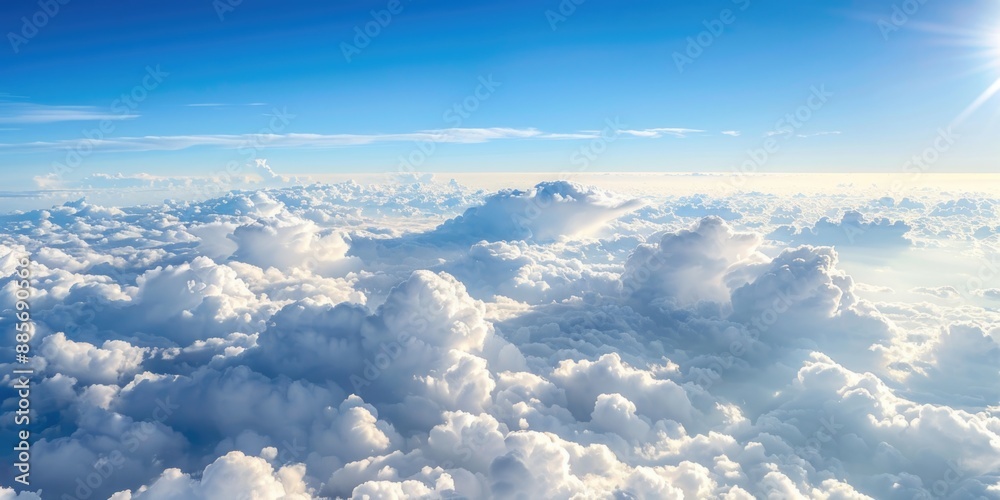 Fototapeta premium A vast expanse of fluffy white clouds stretches out beneath a clear blue sky