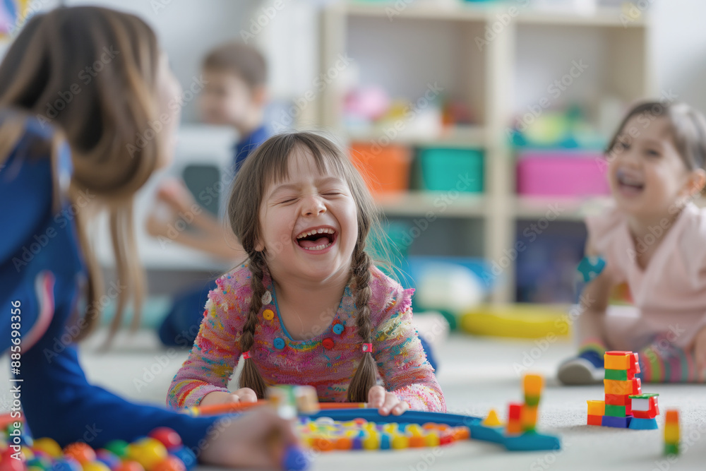Fototapeta premium Laughing girl with Down syndrome playing with colorful toys on the floor in a bright classroom. Her joyful expression and engaged activity create a cheerful and inclusive atmosphere