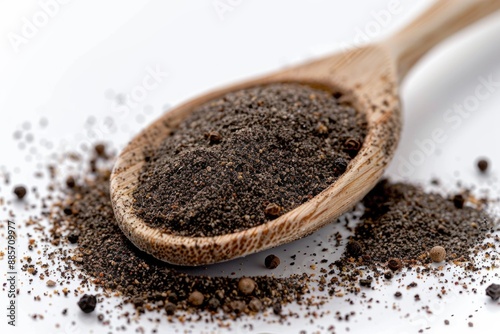 A close-up of a wooden spoon filled with black pepper powder, perfect for use in cooking or as a prop