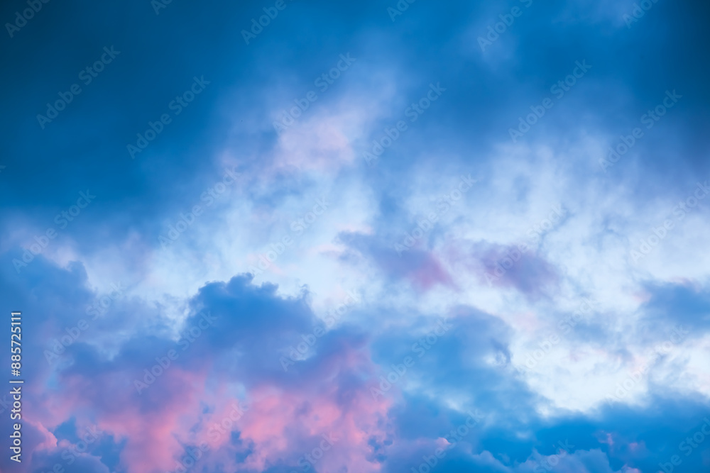 Obraz premium Blue morning sky is in pink clouds. Sunrise clouds are in vanilla colours. Beauty in nature. Twilight time, golden hour. Details of evening sunset. Natural abstraction. Peace concept. Panoramic view