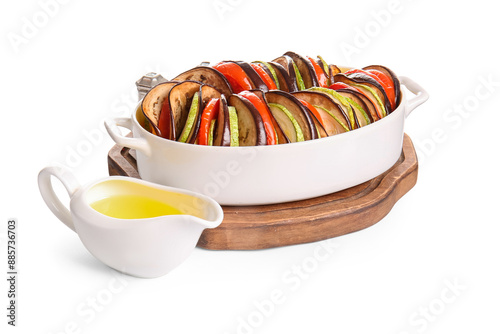 Baking dish of tasty Ratatouille and oil on white background