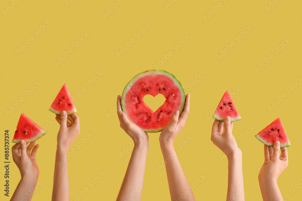 Φωτογραφία Women holding pieces of ripe watermelon and slice with heart on yellow backgroun
