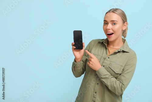 Happy young woman showing m...
