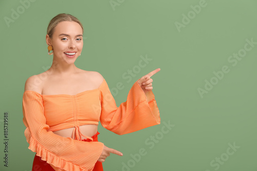 Pretty young woman pointing...
