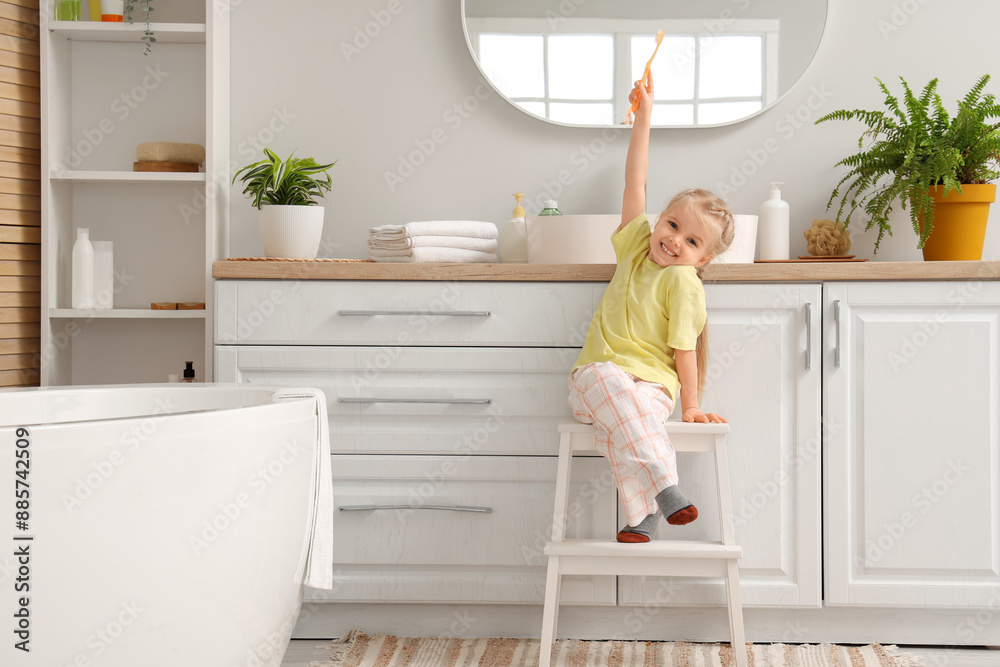 Cute little girl with toothbrush in bathroom Cute little girl with toothbrush in bathroom