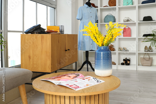 Vase with flowers and magaz...