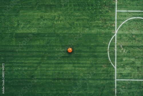 A top view of a soccer field captures the moment a striker takes a shot at the goal photo