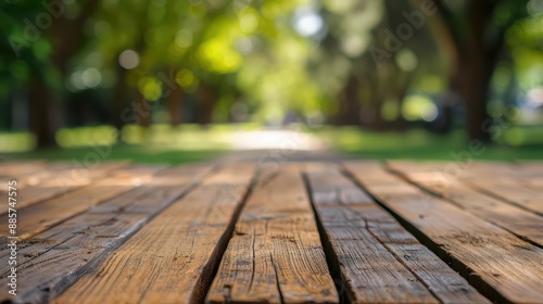 In the foreground, a selected focus empty wooden table with copy space stands, with the background fading into a blur of a serene park