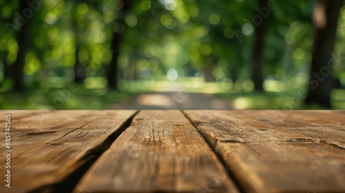 In the foreground, a selected focus empty wooden table with copy space stands, with the background fading into a blur of a serene park