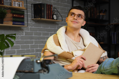 Male author with book and v...