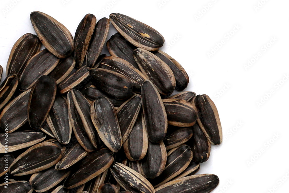Roasted sunflower seeds on white background. Roasted sunflower seeds on white background.