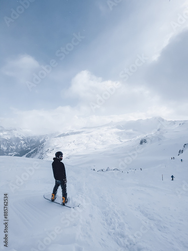 Snowboarder enjoying the view in the swiss alps