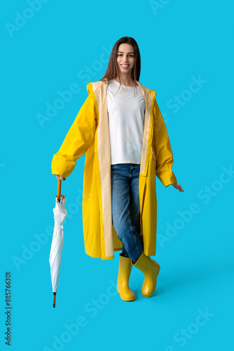 Young happy woman in rainco...