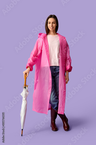 Young woman in raincoat wit...
