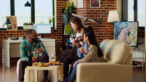 Photography Multiracial group of people having entertaining conversation during their friendship celebration at home