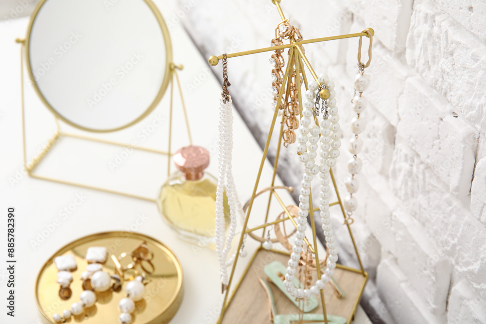 Stand with different jewelry and perfume bottle on dresser, closeup Stand with different jewelry and perfume bottle on dresser, closeup