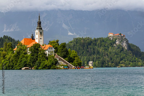 Panoramic view from Lake Bled, beauty heritage in Slovenia. Island with church and castle in the background create a dream setting. View from Ojstrica and Mala Osojnica with the heart-shaped bench. photo