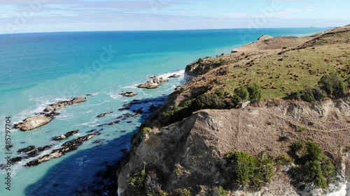 aerial panorama of beautiful nape nape beach in north canterbury, new zealand; black sand beach with turquoise water and large white cliffs	 photo