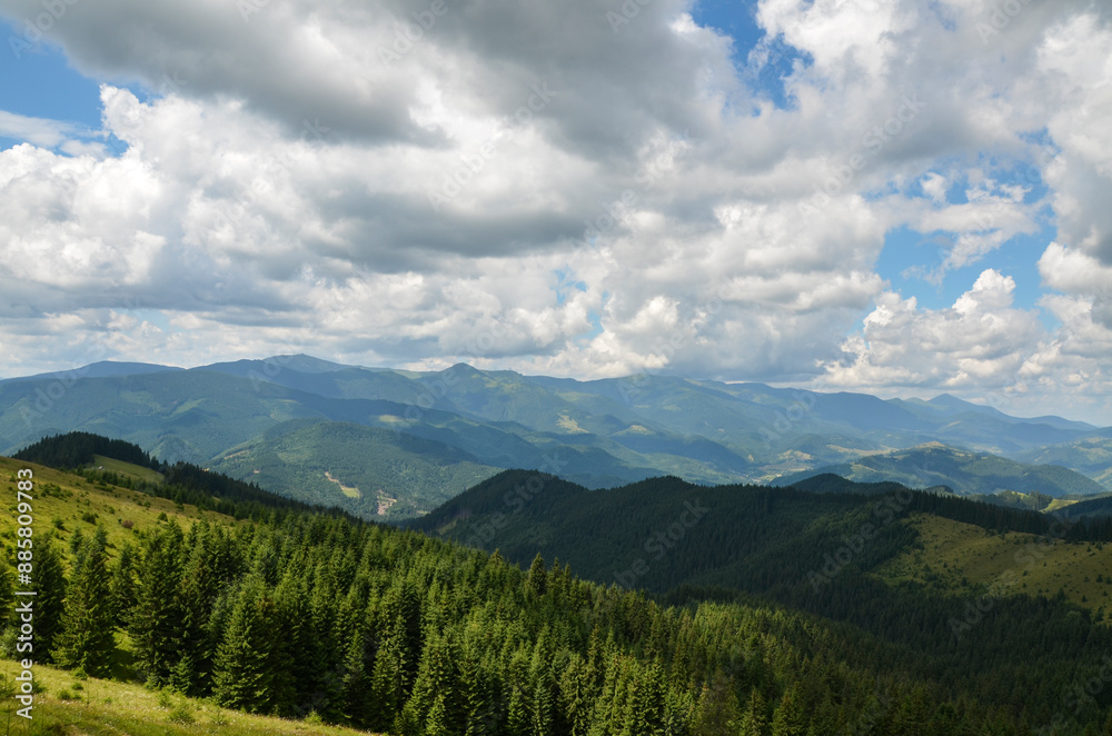 Rolling hills adorned with dense forests. The lush greenery in the foreground contrasts with the layers of mountains in the background, creating a sense of depth under vast sky, dotted with clouds Rolling hills adorned with dense forests. The lush greenery in the foreground contrasts with the layers of mountains in the background, creating a sense of depth under vast sky, dotted with clouds