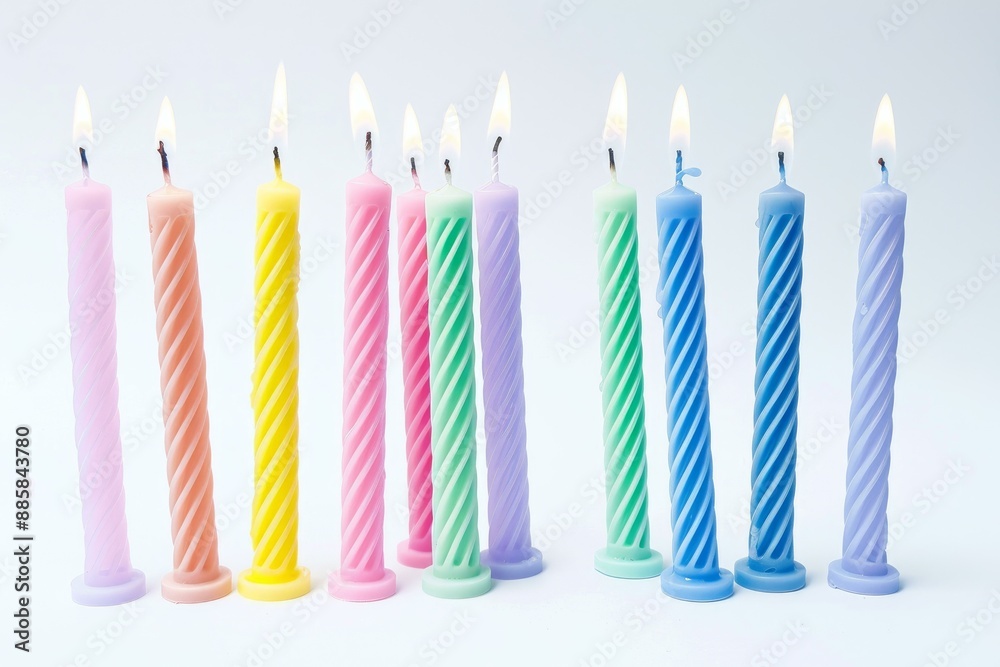 Eleven lit birthday candles are standing in a row on a white background Eleven lit birthday candles are standing in a row on a white background