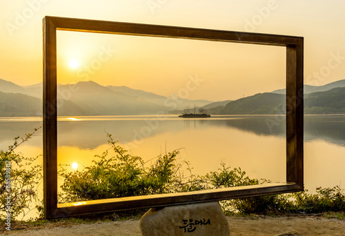 Yangsu-ri, Yangpyeong-gun, Gyeonggi-do, South Korea - October 1, 2012: Sunrise view of photo zone frame against trees and calm Namhan River at Dumulmeori
 photo