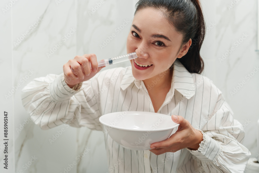 woman making nasal wash with using sryinge flushing inside nose woman making nasal wash with using sryinge flushing inside nose
