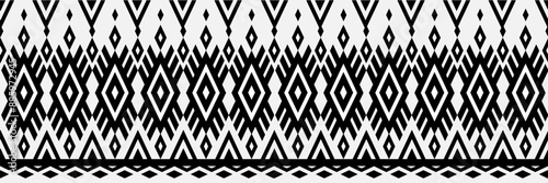 A black and white patterned fabric with diamond shapes. The pattern is very intricate and detailed. The fabric is likely to be used for clothing or home decor