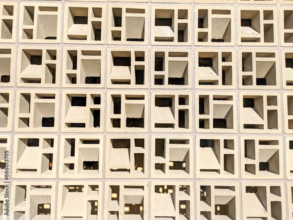 A close-up of hollow concrete blocks arranged for ventilation showcases their geometric precision and functional beauty.
