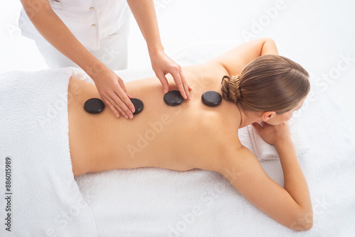Young woman getting massaging treatment over white. Spa, healthcare and recreation concept.