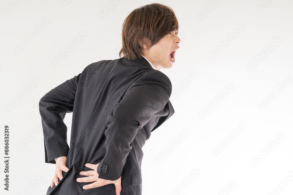 腰痛に悩む若い男性 腰痛に悩む若い男性