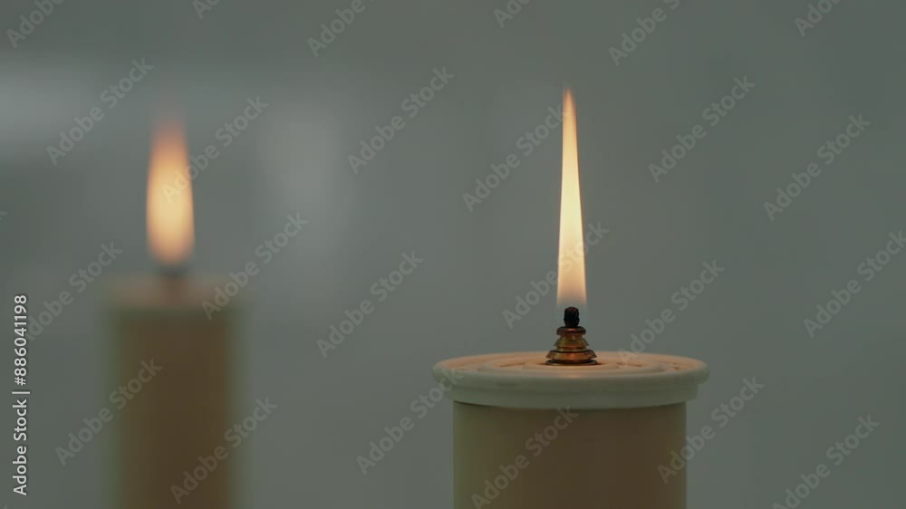 Two lit candles with a calm flame, creating a serene and peaceful ambiance Two lit candles with a calm flame, creating a serene and peaceful ambiance