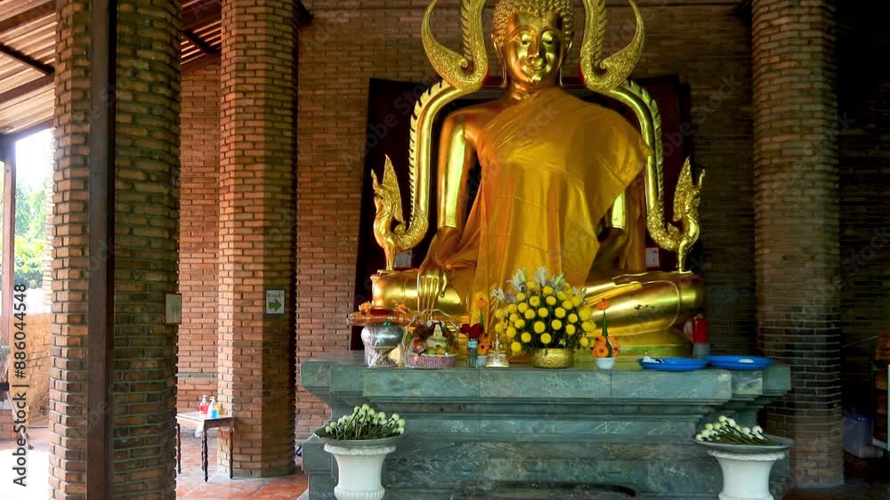 Golden Buddha statue at Wat Yai Chaimongkhon temple in Ayutthaya, Thailand.