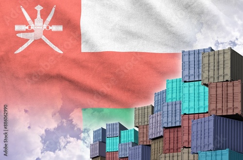 Oman flag and big stack of shipping cargo containers in docks with sky background close up photo