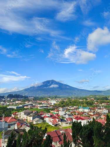 The photo of clouds and Mount Singgalang was taken from the top of the hill and shows a view of the city below photo