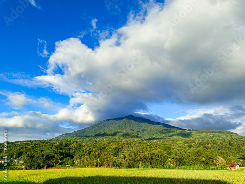 photo of Mount Singgalang covered in beautiful clouds and blue sky photo