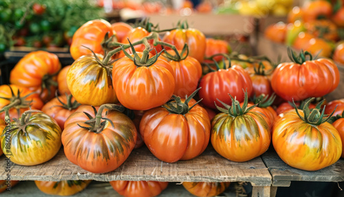 An array of ripe tomatoes on a wooden table, representing natural, fresh ingredients